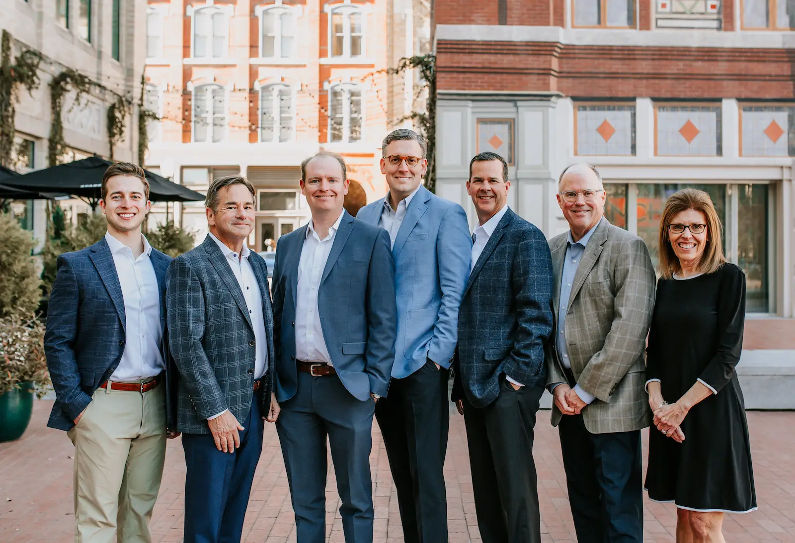 Group photo of the Lacy Malone Ryder & Menefee, PLLC Partners, Associates, and one of the Senior Counsel members standing outside. From left to right, the photo includes: Blake Garcia, David Menefee, Ryan Horner, Justin Malone, Jeff Lacy, Tom Ryder, and ML Menefee.